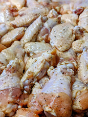 raw chicken wings marinated ad ready for cooking