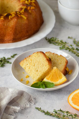 A piece of orange cake on a white dish 