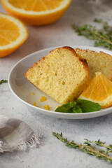 A piece of orange cake on a white dish. Close-up