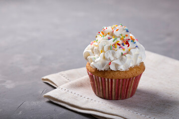 Tasty party cupcakes on the table. Cupcakes with whipped cream.