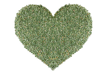 Heart shaped background or texture of green dry peas on on isolated background.