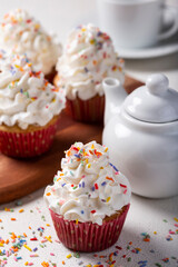Tasty party cupcakes on the table. Cupcakes with whipped cream.
