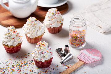 Tasty party cupcakes on the table. Cupcakes with whipped cream.