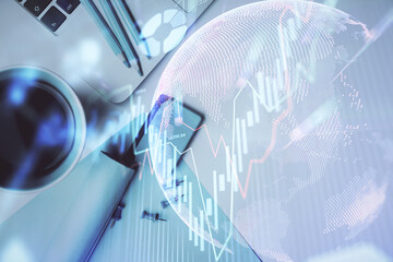 Double exposure of forex graph drawing over desktop background with computer. Concept of financial analysis. Top view.