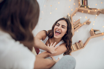 Obraz premium Woman and girl having fun playing at home