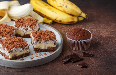 Delicious homemade chocolate dessert with banana, ricotta (cremcheese, mascarpone) and brownie. Mole cake. Portions of pie in a gray plate. Selective Focus