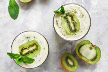 Yogurt with kiwi in a glass. Fruit and berry smoothie. Milkshake with kiwi and banana. Healthy...