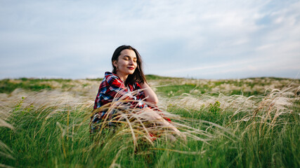 girl in a red skirt enjoys the summer in the field