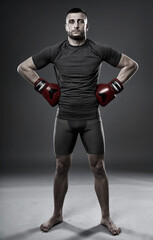 Fototapeta na wymiar MMA fighter posing on gray