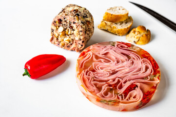 Pork meat products, ham in aspic, nut pate, pepper and bread.