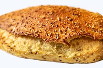 Wholemeal bread with seeds, nicely inflated and cracked with nice texture,  in golden color on surface on white background. Bakery product.