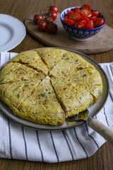 Spanish tortilla potato omelette top view. Sliced round omelette made of onion eggs and potatoes. Plated and ready to serve. Spanish tapas
