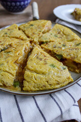 Spanish tortilla tapas dinner party. Homemade potato omelette for sharing with tomato salad. 