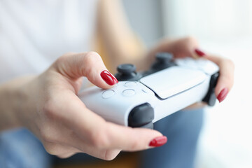 Fototapeta premium Woman holding joystick for computer game closeup