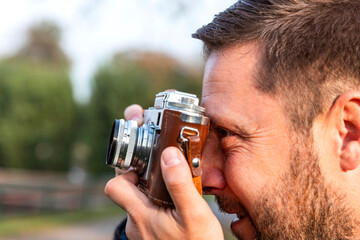 Fototapeta premium Photographer with vintage analogue film camera outdoors