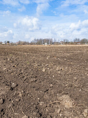 Arable land. Preparing field for planting. Plowed soil in spring time . Agricultural work.