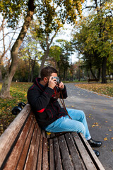 Photographer with vintage analogue film camera outdoors