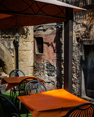 Bright orange tablecloths decorate ornate Sicilian outdoor restaurant