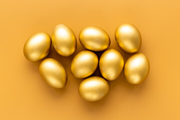 Golden eggs flat lay. Save money. Wealth and good luck symbol
