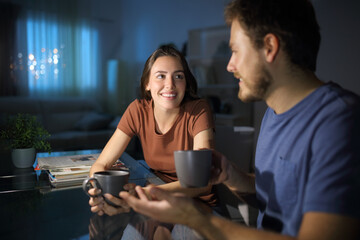 Happy couple talking in the night at home