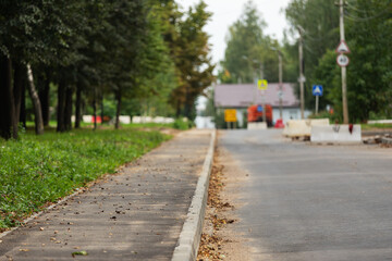 poorly executed road repairs. replacing the old curb stone with a new one