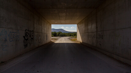 inside a tunnel with landscape at background