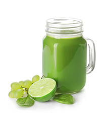 Mason jar of healthy green smoothie and ingredients on white background
