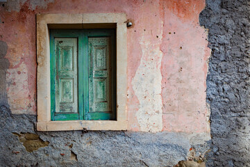 Colorful shuttered window in typical stone wall in Sicily