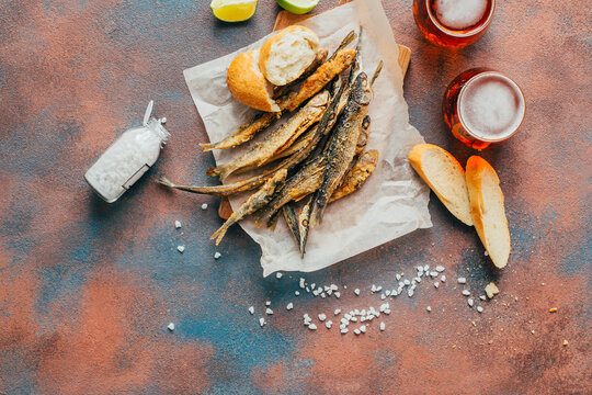 top view of fried fish, beer, baguette