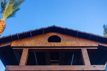 Garden big wooden bird feeder outdoors in tropical resort