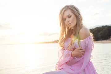 Fototapeta na wymiar Lovely female model woman in pink dress outdoor