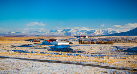 Farm buildings dot the scenic landscapes of Iceland in Winter