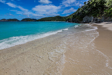 Gentle ocean water flows on to white sandy beaches of St. John