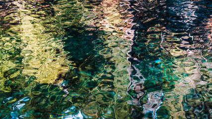 A pattern in water created by reflection of trees and colorful blue water from Tamolitch Blue Pool,...