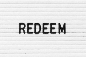 Black color letter in word redeem on white felt board background