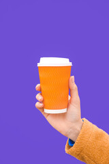 Woman with takeaway cup of tasty latte on color background