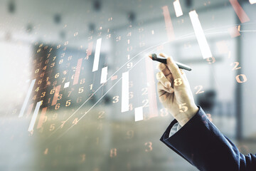 Multi exposure of analyst hand with pen working with virtual abstract financial diagram on blurred...