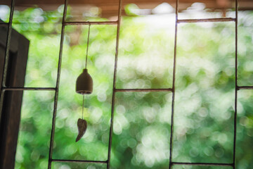 Abstract blurred Window bell Blurry  with green leaves background by defocused effect. use for background or backdrop.  Natural background and wallpaper