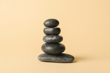 Stack of spa stones on color background