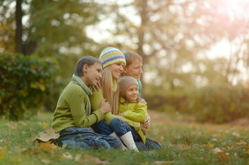 Happy smiling family relaxing in autumn park