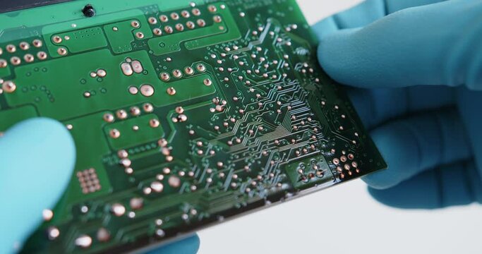 Close up shot of technician inspect the chips of electronic device