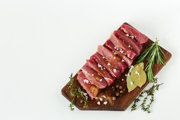  
chunks of raw meat. fresh meat sliced with seasonings and spices on a wooden board. copy of the space