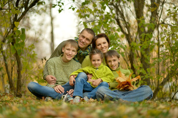 Fototapeta na wymiar Family relaxing in autumn park