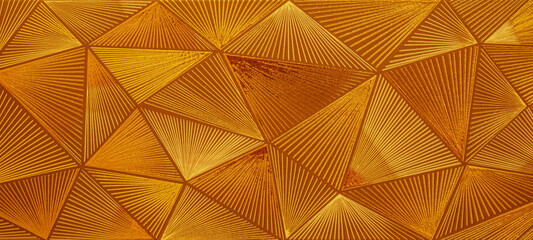 Abstract triangular gold mosaic tile wallpaper texture with geometric fluted triangles of metallic...