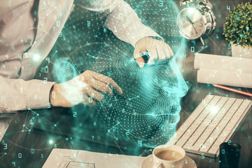 Double exposure of man's hand holding and using a digital device and brain hologram drawing. Data concept.
