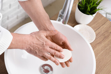 Man washing hands in bathroom