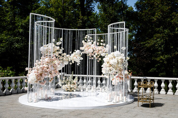 Wedding arch for wedding of newlyweds. Wedding celebration outdoors in the park. Wedding ceremony decoration