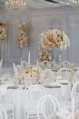 Festive wedding table setting with flowers, napkins, cutlery, glasses, bright summer table decor. Wedding decor