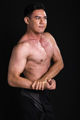 Fototapeta premium Portrait of asian muscular man standing on black background