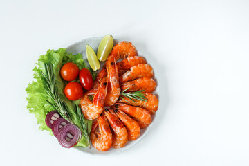 barbecue shrimp in a plate with herbs and vegetables, fried shrimp with lime, Restaurant menu, Mediterranean cuisine